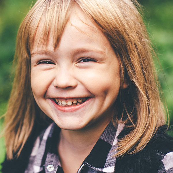 Young Girl Smiling Outdoors