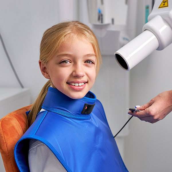 Girl receiving a digital x-ray at the dental office.